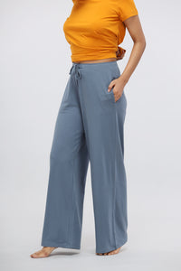 China Blue Supima® flared lounge pant paired with a vibrant orange top.