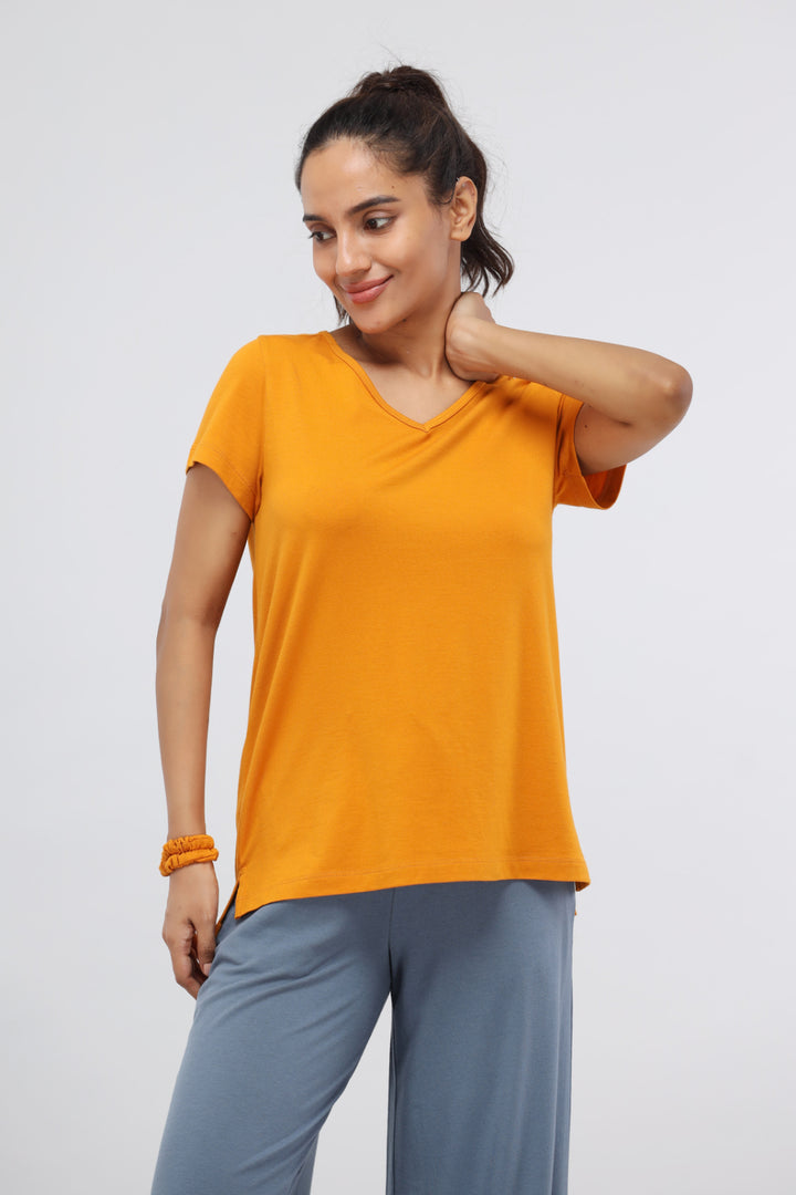 Desert Sun Supima® V Neck Casual Top in orange on model.