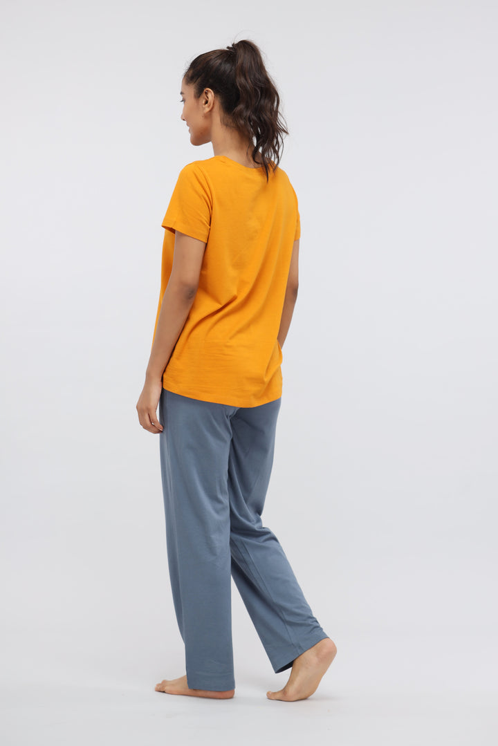 Model wearing yellow top and blue lounge pants, showcasing comfort and style.