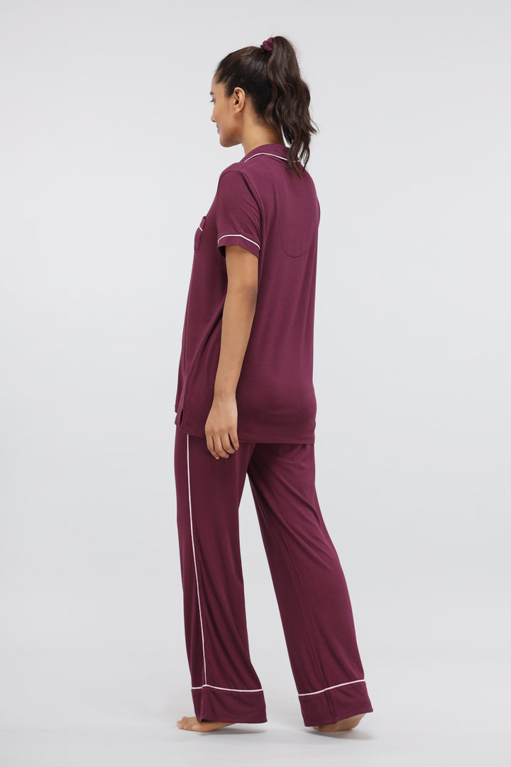 Wine modal pajama set with button-down top and piping details.