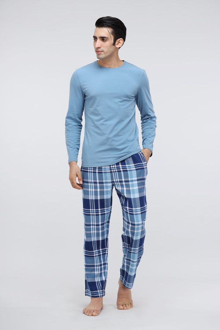 Men's plaid flannel pajamas showcased on a model.