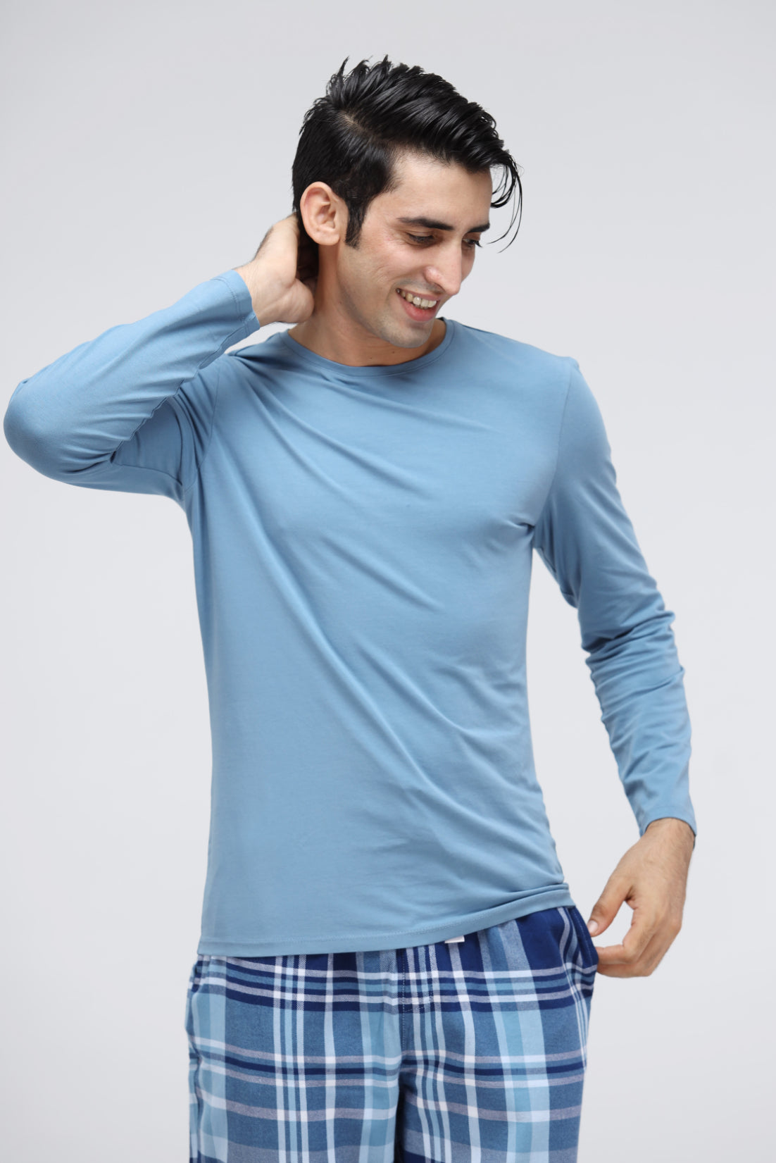 Men's blue cotton full sleeve t-shirt model wearing plaid pants.