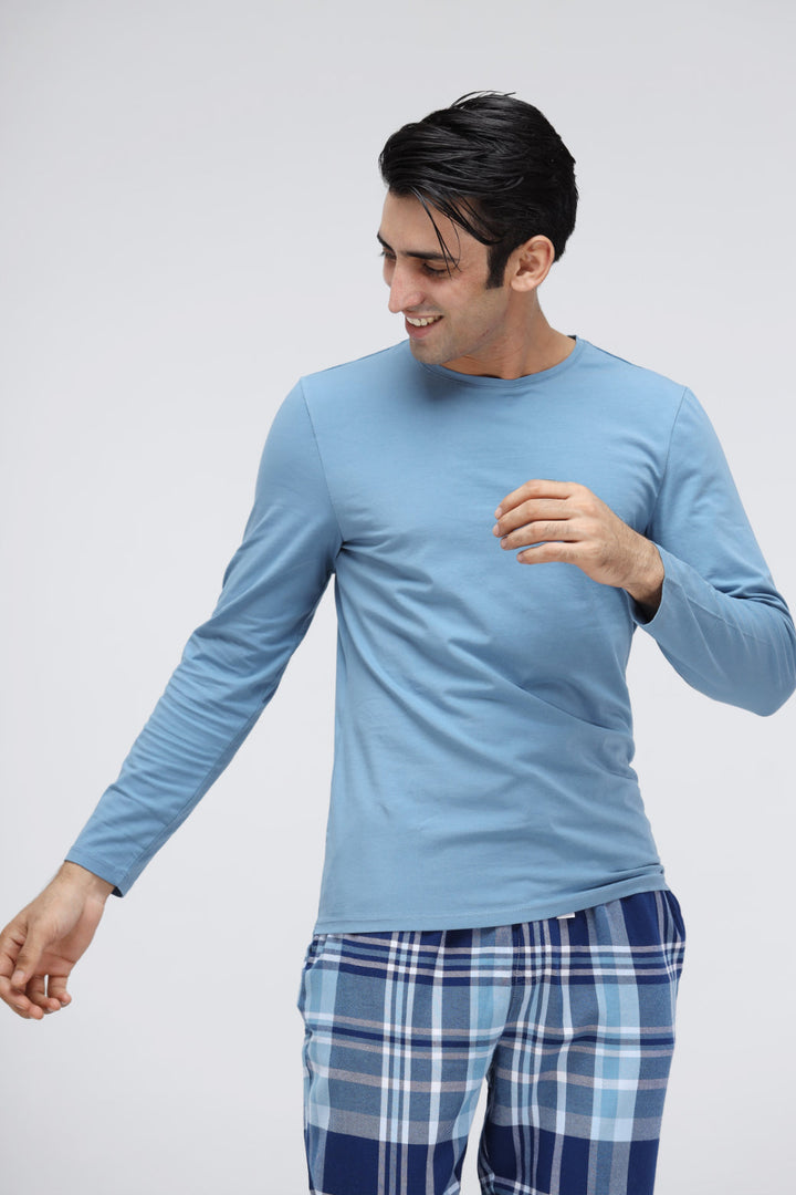 Men's plaid flannel pajamas with long-sleeve blue top and checked pants.