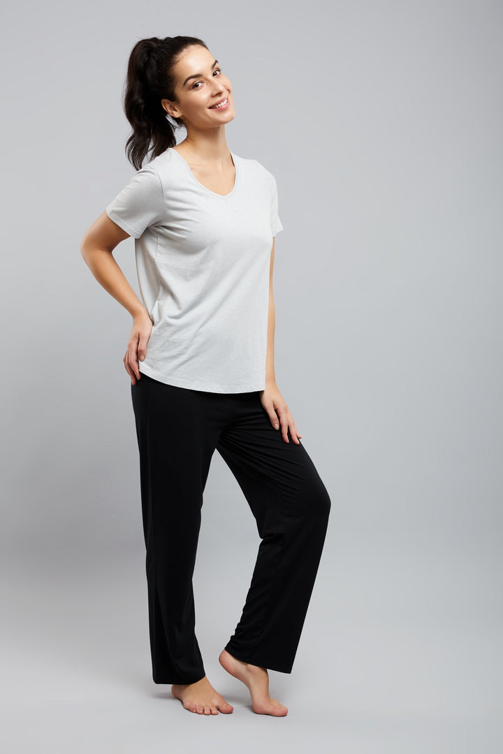 Stylish woman in Lazy Lounge Pajamas, relaxed and smiling.