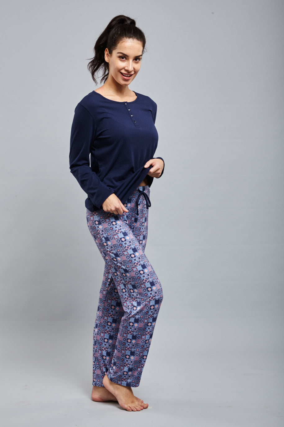 Model wearing Classic Mosaic Pajamas in stylish navy and patterned design.