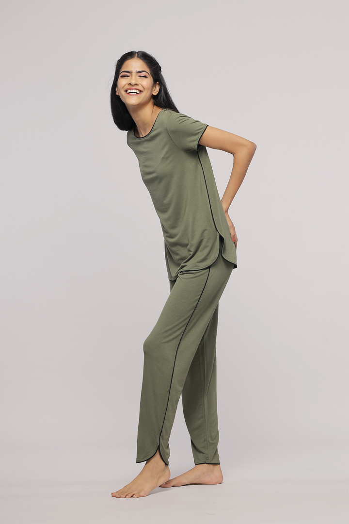 Olive green multipurpose lounge set model smiling in stylish outfit.