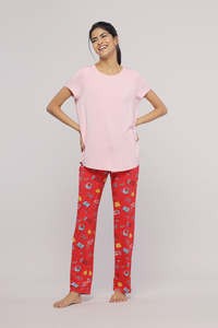 Smiling model in Pink Mist Pajama Set with colorful pants.