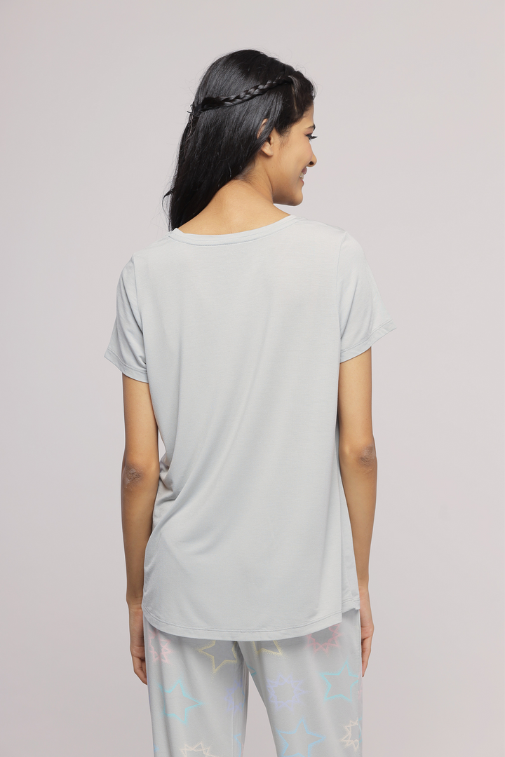 Woman wearing Starlit Cuffed Pajamas, showcasing the back design.