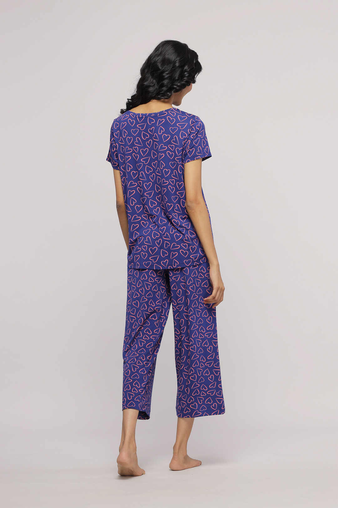 "Sweetheart Capri stylish pajama set with heart pattern in purple."