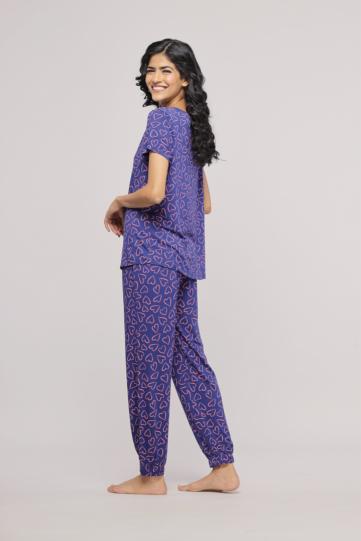 Model showcasing Sweetheart Pajamas in purple heart print design.