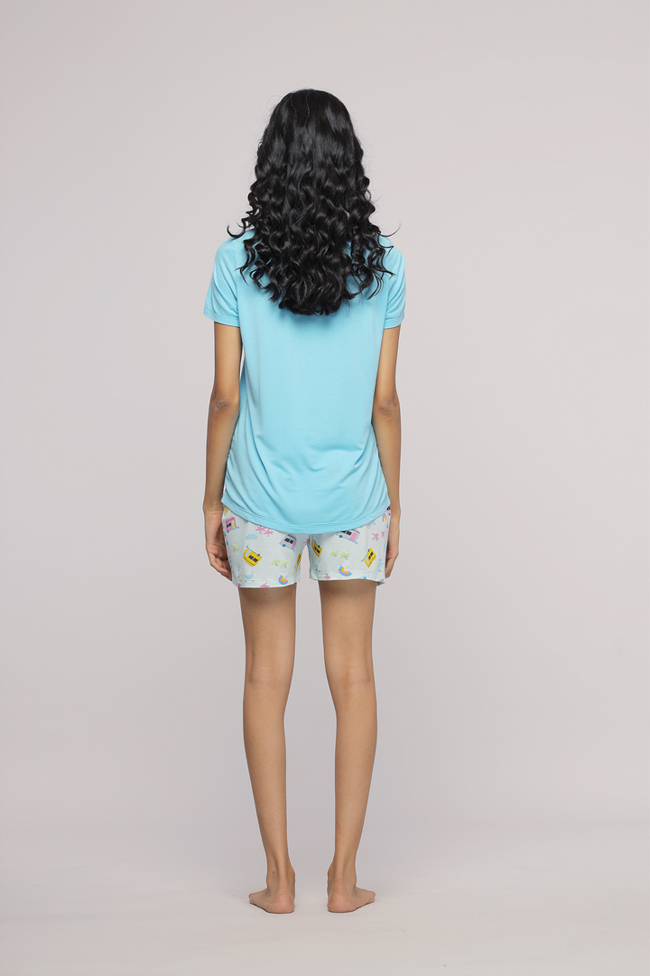 Back view of a woman wearing The Voyager Short and blue tee.