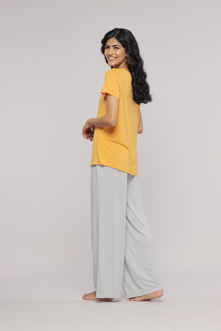 Zen Grey Flared Pajama Set with yellow top, model smiling.